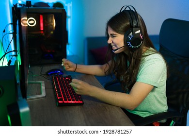 Caucasian Woman Feeling Happy And Excited While Doing A Winning Gesture Because Of Her Victory In An Online Video Game At Her Gaming Computer PC