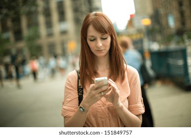 Caucasian woman female using smart phone cellphone smartphone walking streets New York City - Powered by Shutterstock