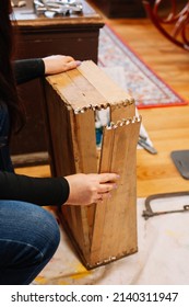 Caucasian Woman Fixing Wooden Old Box By Putting It Together In Home Workshop. Giving Old Things New Life. Reuse Of Aged. Sustainable Actions For Helping Planet.