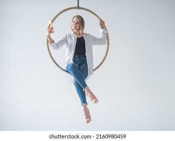 Caucasian Woman Gymnast On An Aerial Hoop Takes A Selfie On A Smartphone. 