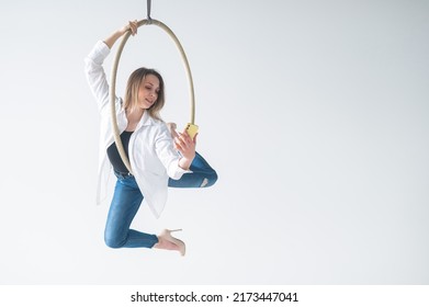 Caucasian Woman Gymnast On An Aerial Hoop Takes A Selfie On A Smartphone. 