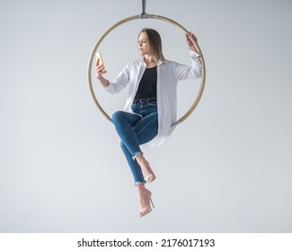 Caucasian Woman Gymnast On An Aerial Hoop Takes A Selfie On A Smartphone. 