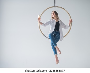 Caucasian Woman Gymnast On An Aerial Hoop Takes A Selfie On A Smartphone. 