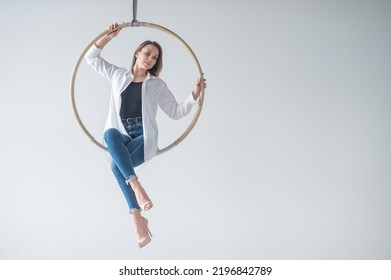 Caucasian Woman Gymnast On An Aerial Hoop Takes A Selfie On A Smartphone. 