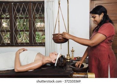 Caucasian Woman Having Ayurveda Shirodhara Treatment In India, Kerala State