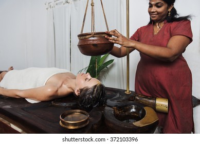 Caucasian Woman Having Ayurveda Shirodhara Treatment In India, Kerala State