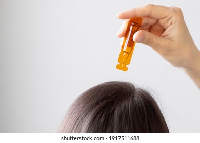 Caucasian Woman Holding An Ampoule Of Vitamins And Apply To The Hair Or Skin, Close-up, Hair And Skin Oil, Aminexil, Hair Restoration