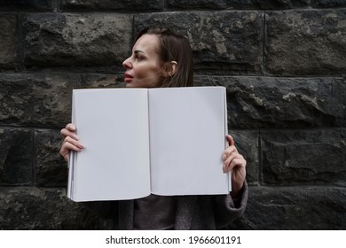 Caucasian Woman Is Holding Beauty Fashion  Magazine With A Blank Pages