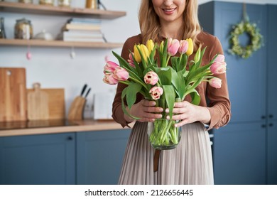 Caucasian woman holding bouquet of fresh tulips 