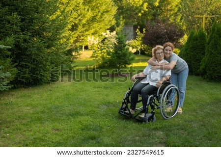 Similar – Daughter hugging senior mother in wheelchair