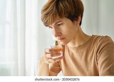 Caucasian Woman Inhaling Aroma Of Perfume Bottle. Loss Of Smell Due To Coronavirus. Concept Of Long-term Effect Of Covid19 Pandemic. Self-checking For Infection And Receptor Blindness. Lack Of Sense