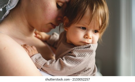 Caucasian Woman Mother Holding His Small Baby Girl While Standing By The Window At Home Looking To The Side Real People Parenthood Bonding Love And Family Concept Copy Space