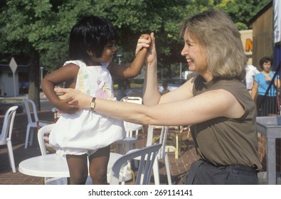 A Caucasian Woman Playing With An Indian Child, Chevy Chase, MD