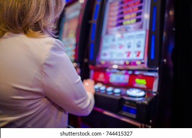 Caucasian Woman Playing Video Games In The Las Vegas Casino. Video Slot Machines.