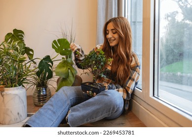 caucasian woman pruning bonsai at home - Powered by Shutterstock