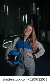 Caucasian Woman Puts On A Helmet Before Flying In A Wind Tunnel. Free Fall Simulator.