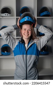 Caucasian Woman Puts On A Helmet Before Flying In A Wind Tunnel. Free Fall Simulator.