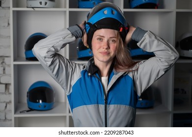 Caucasian Woman Puts On A Helmet Before Flying In A Wind Tunnel. Free Fall Simulator.