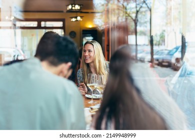 Caucasian Woman Seen Through A Glass Window Inside A Restaurant