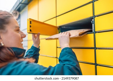 Caucasian Woman Send Or Receive Parcel With Yellow Self Service Post Terminal Machine. 