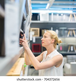 Caucasian Woman Shopping For Furniture, Recliner And Home Decor In Store.