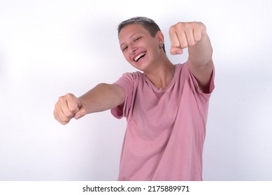 Caucasian Woman With Short Hair Wearing Pink T-shirt Over White Wall  Imagine Steering Wheel Helm Rudder Passing Driving Exam Good Mood Fast Speed