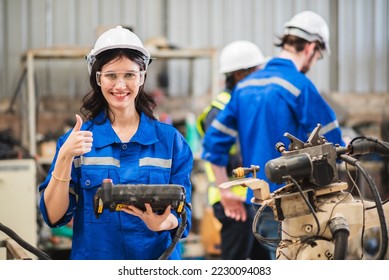Caucasian woman specialist engineer in uniform smiling and showing thumb up and holding robotic arm controller for working in smart industrial factory. - Powered by Shutterstock - Get 15% off with code: PIKWIZARD15