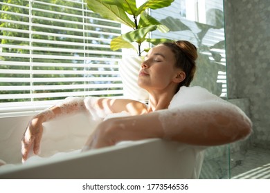 A Caucasian woman spending time at home, relaxing, having a foamy bath. Lifestyle at home isolating, social distancing in quarantine lockdown during coronavirus covid 19 pandemic. - Shutterstock ID 1773546536