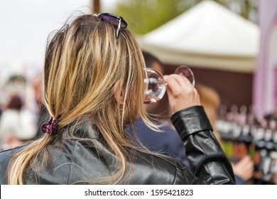Caucasian Woman Tasting Wine Outdoor During Festival.