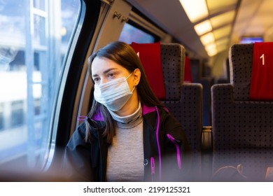 Caucasian Woman Traveler In Face Mask Sitting Inside Train And Looking Out Window.