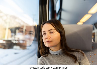 Caucasian Woman Traveler Sitting Inside Train And Looking Out Window.