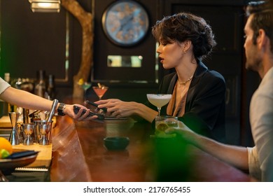 Caucasian Woman Using Mobile Banking Application On Smartphone Scan QR Code Making Online Payment While Hangout Party At Restaurant Bar. Electronic Banking And Contactless Payment Technology Concept.