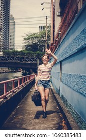 Caucasian Woman Walking And Holding Guitar Case