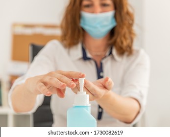 Caucasian Woman Washing Hands With Alcohol Gel At Office - Corona Virus Hand Sanitizer Bottle - New Normal Concept