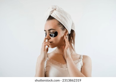 Caucasian woman in whie towel with collagen patch on face, skincare.  Natural cosmetic for beauty care. Concept beauty treatments