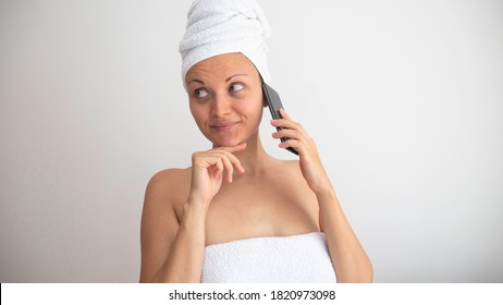 Caucasian Woman Wrapped In A Towels Talking On The Phone. Negative Space Or Copy Space For Text.