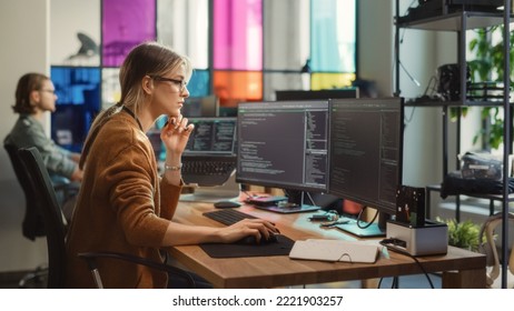 Caucasian Woman Writes Lines of Code on Desktop PC with Multiple Displays and a Laptop in Stylish Office. Professional Female Data Scientist Using Software To Analyze Information from Internet. - Powered by Shutterstock