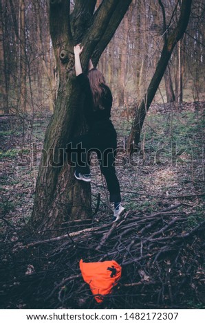 Similar – Woman walking on a fallen tree trunk