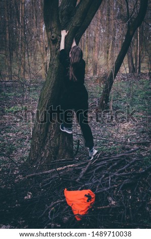 Similar – Woman walking on a fallen tree trunk