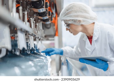 caucasian women worker working in water plant factory clean hygiene process in bottling drinking water machine line. - Powered by Shutterstock