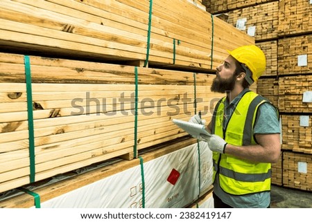 Caucasian Wooden industry factory working man checking stocks in wood industrial distribution warehouse, beard man inspecting stack of pile wood stock, male worker works in wooden distribution storage Stock photo © 