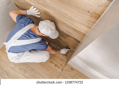 Caucasian Worker Grouting And Sealing Shower Cabin Using Silicone And Grout. Bathroom Remodeling. 