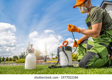 Caucasian Worker In His 40s Preparing Pest Control Spraying Equipment. Spring Garden Maintenance Theme.