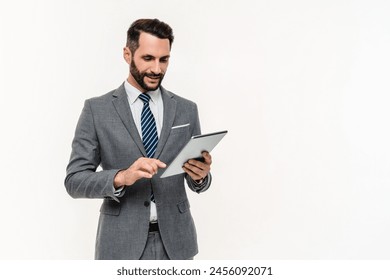 Caucasian young businessman using digital tablet online isolated over white background. Manager accountant hr ceo boss typing online messages on social media - Powered by Shutterstock