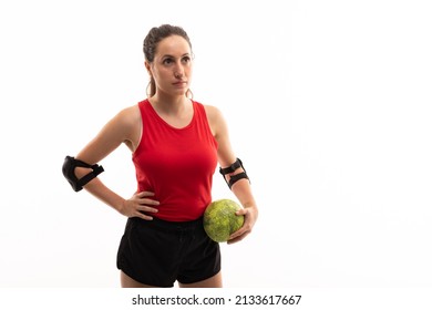 Caucasian young female handball player looking away while standing with ball and hand on hip. unaltered, white background, copy space, sport, contemplation, sports uniform and team handball. - Powered by Shutterstock