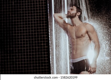 Caucasian Young Good Looking And Attractive Man With Muscular Body Standing Under Running Water In Shower Room, Take Care Of Skin And Body