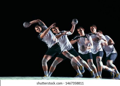 Caucasian Young Handball Player In Action And Motion In Mixed And Strobe Light On Black Studio Background. Fit Professional Sportsman. Concept Of Sport, Movement, Energy, Dynamic, Healthy Lifestyle.