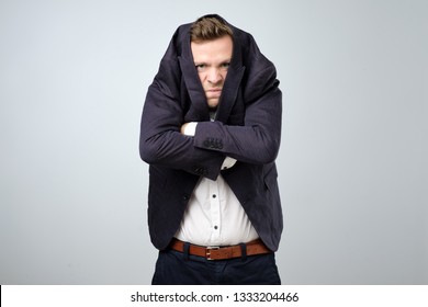 Caucasian Young Man In Too Big Suit. He Is Offended And Looking Stressed. Looking Silly In A Suit Of Wrong Size