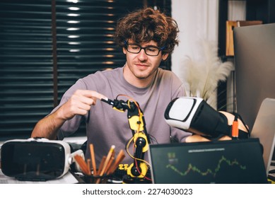 Caucasian young man studying by self in robotic system and Virtual Reality vr glasses controller , freelance programmer coding work at home. - Powered by Shutterstock