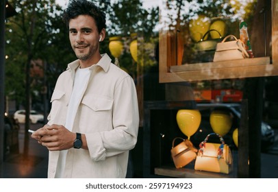 Caucasian young man using smartphone, receiving mobile banking notifications, checking investment updates, managing personal finance, or tracking digital purchases in real-time for financial security